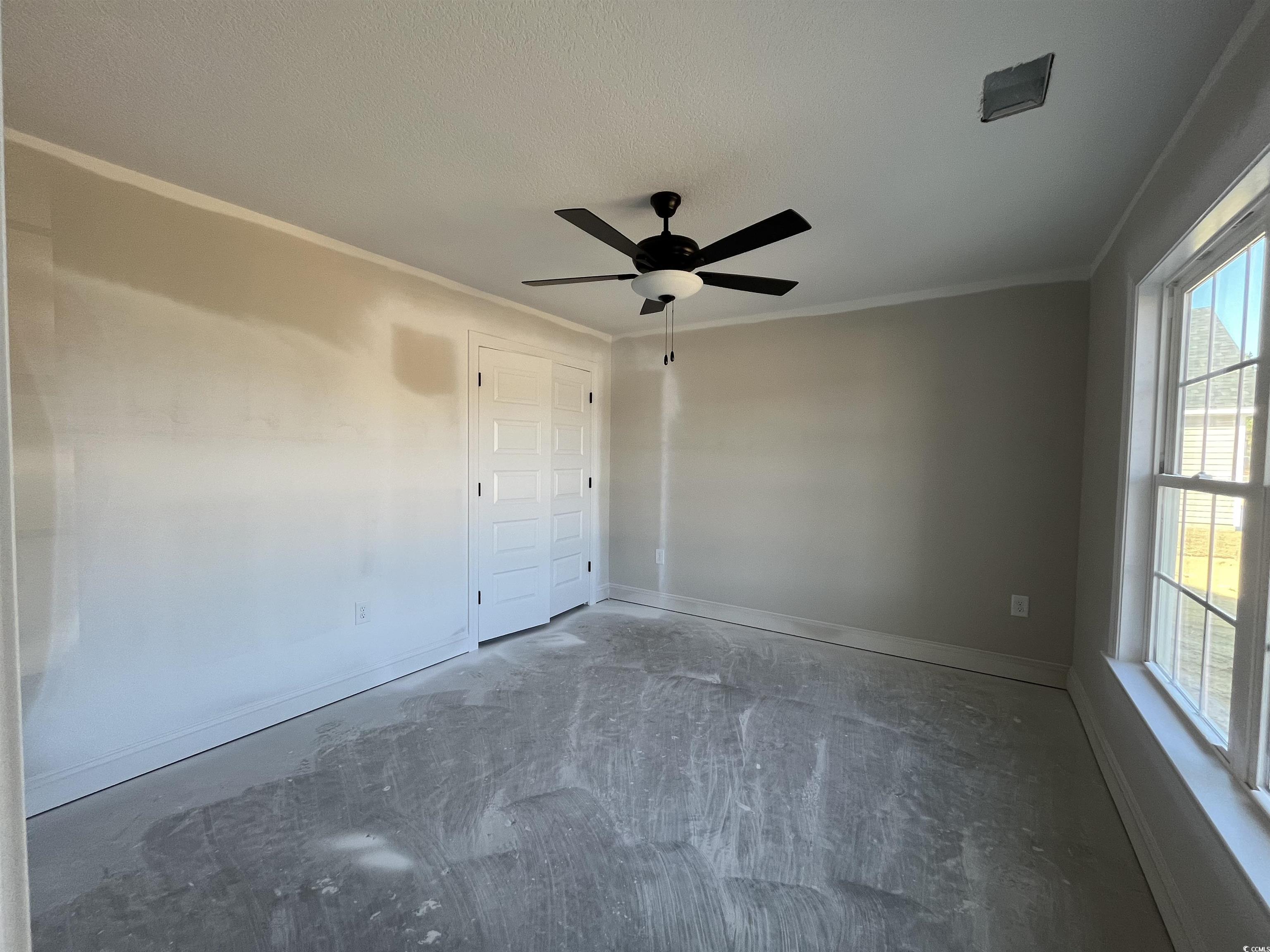 8197 Kerl Road Aynor, SC 29511 - Photo 4 of 9 Unfurnished room with ceiling fan, ornamental mold