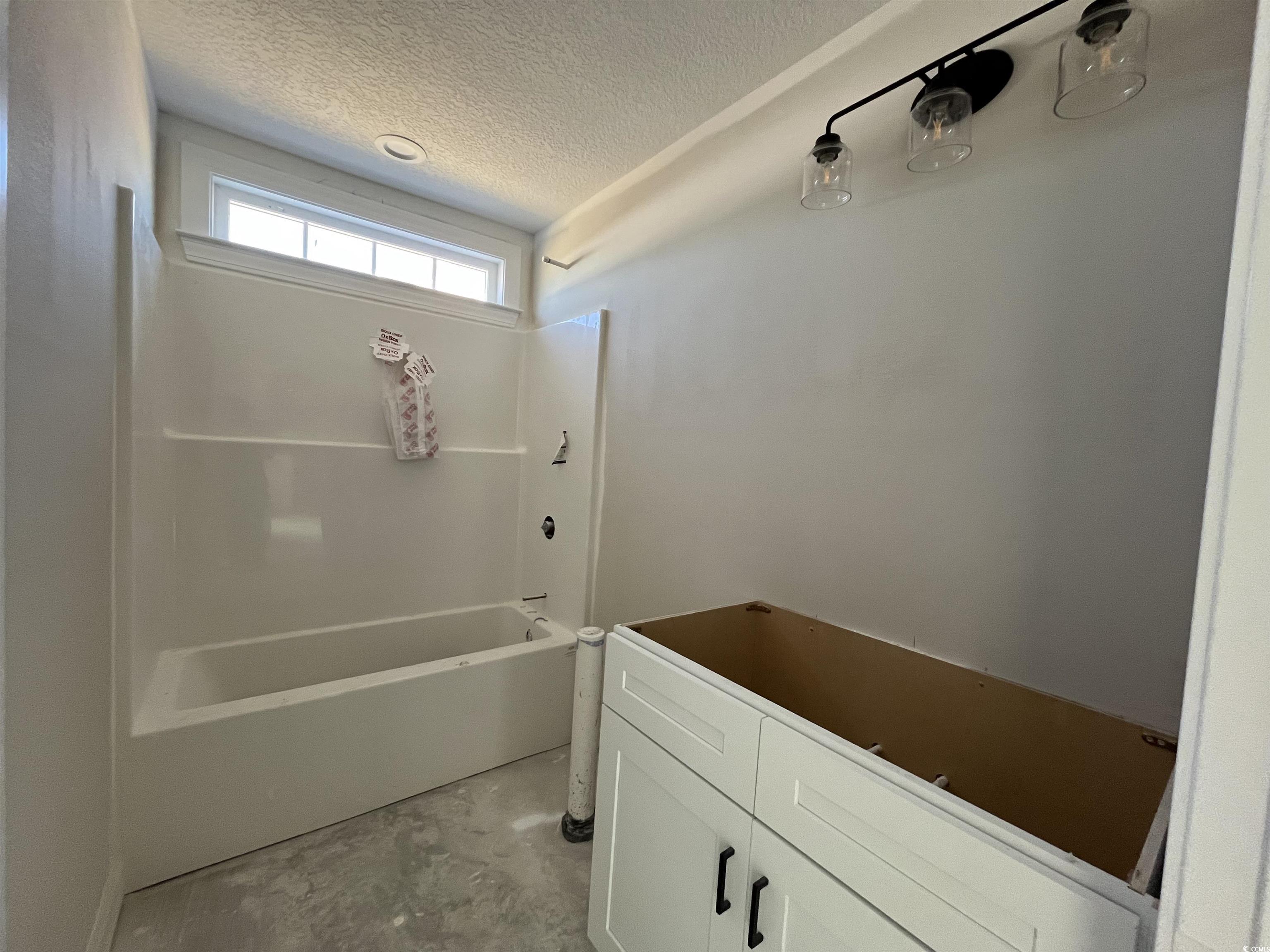 8197 Kerl Road Aynor, SC 29511 - Photo 6 of 9 Bathroom featuring a textured ceiling, concrete fl