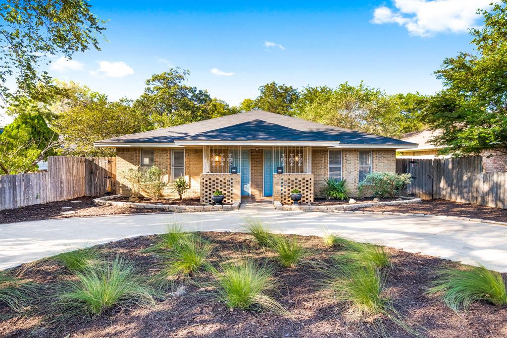 a front view of a house with yard and seating space
