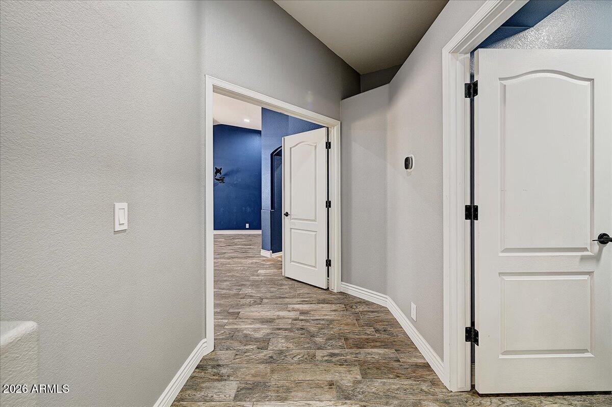 7624 North Citrus Road Waddell, AZ 85355 - Photo 19 of 57 a view of a hallway with wooden floor and closet