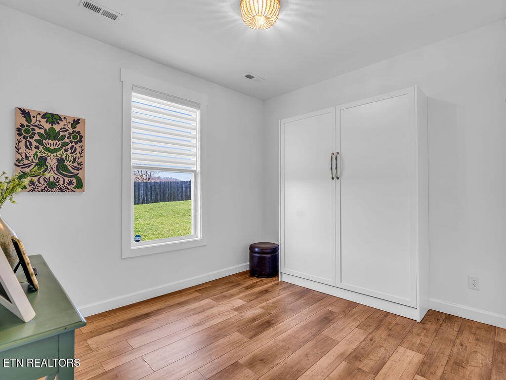 660 Mize Circle Seymour, TN 37865 - Photo 21 of 46 a view of an empty room with a window and wooden floor