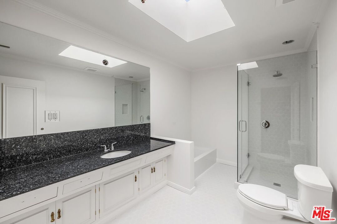 1700 Rising Glen Road Los Angeles, CA 90069 - Photo 15 of 19 a bathroom with a granite countertop sink a toilet and shower