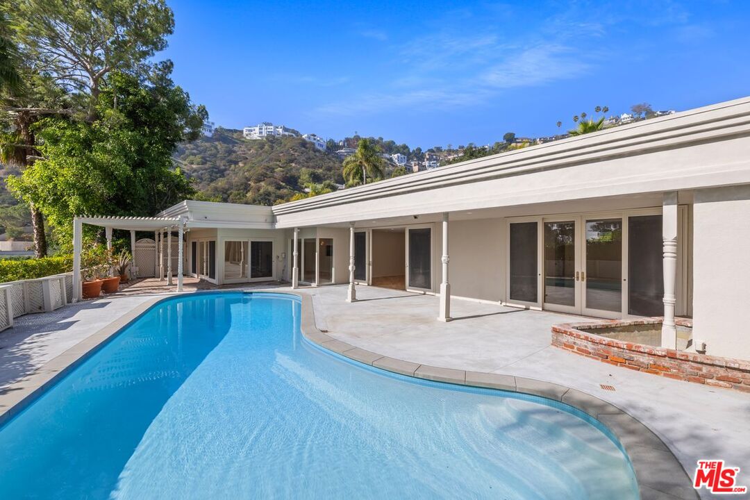 1700 Rising Glen Road Los Angeles, CA 90069 - Photo 17 of 19 front view of a house with a swimming pool