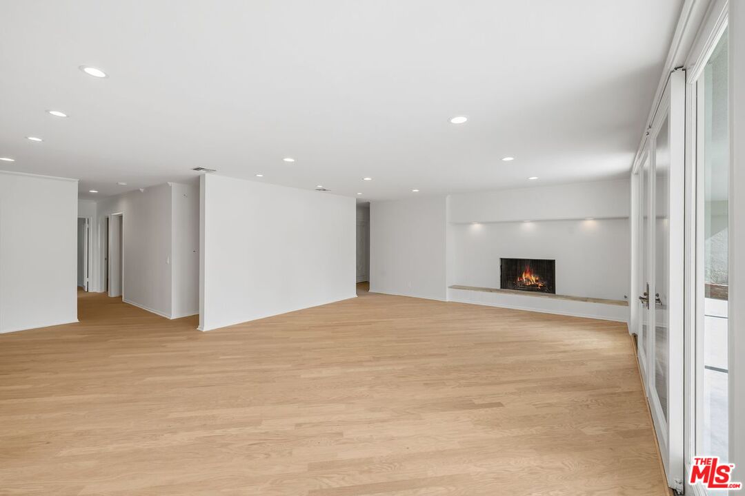 1700 Rising Glen Road Los Angeles, CA 90069 - Photo 6 of 19 a view of empty room with a fireplace