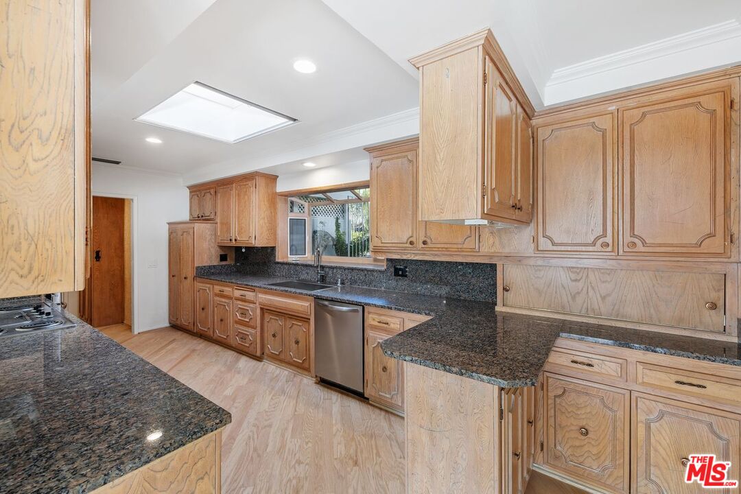 1700 Rising Glen Road Los Angeles, CA 90069 - Photo 8 of 19 a kitchen with stainless steel appliances granite countertop a sink stove and cabinets