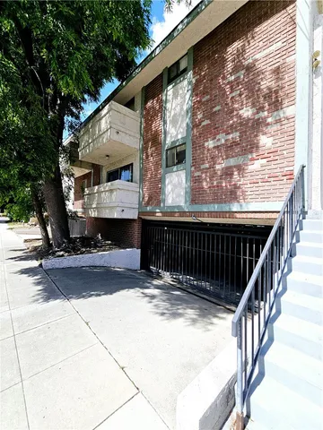 a view of balcony with wooden floor and fence