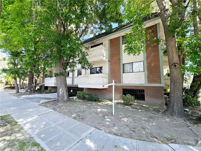 a view of a house with a yard and tree s