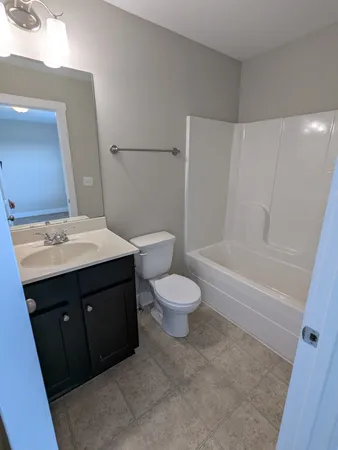 a bathroom with a sink toilet and a mirror