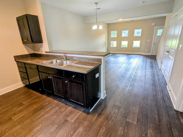a spacious bathroom with a granite countertop sink and a mirror