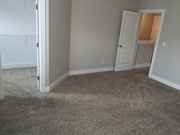 an empty room with a empty space and windows