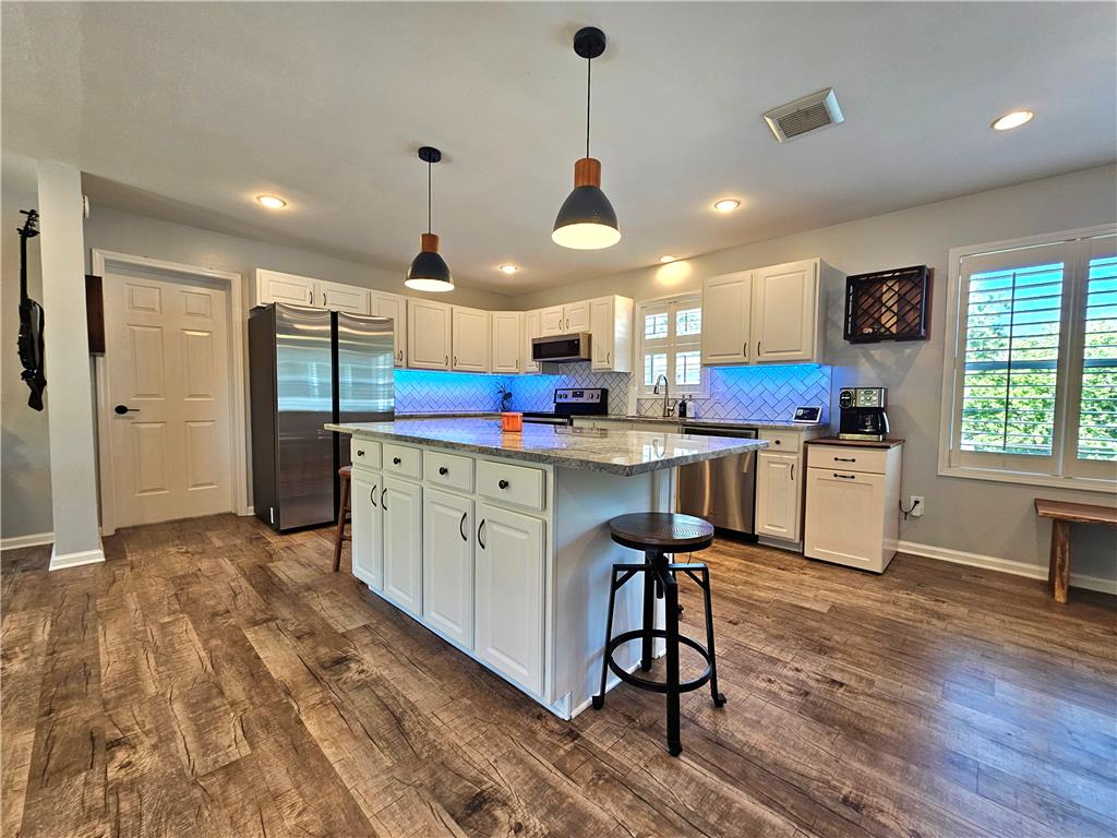 190 Canal Road Easton, PA 18042 - Photo 6 of 39 a kitchen with stainless steel appliances kitchen island granite countertop a sink a stove a refrigerator and island with wooden floor
