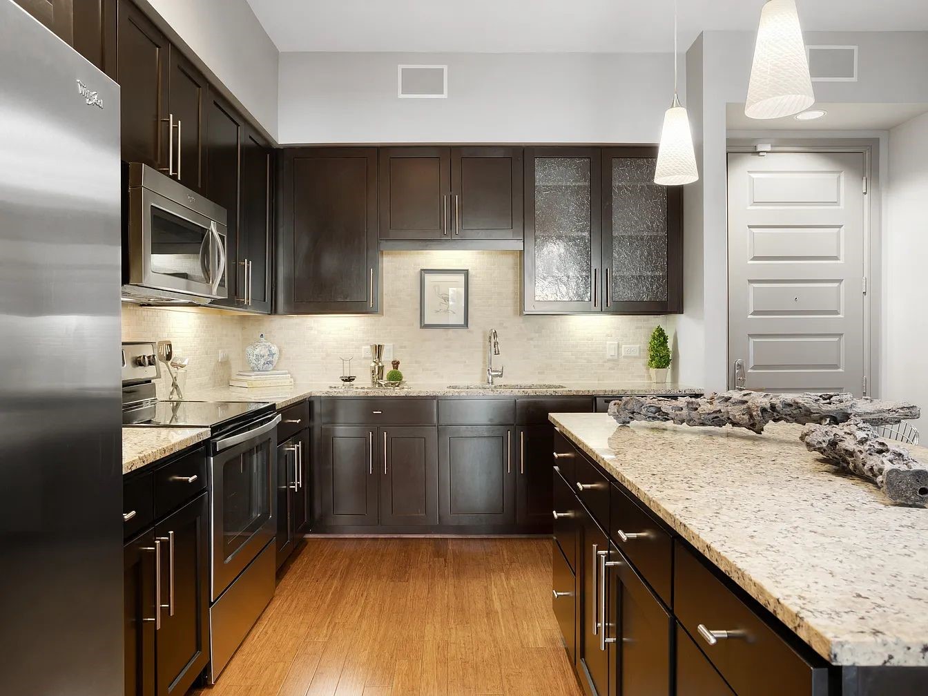 2724 Kipling Street, Unit 220 Houston, TX 77098 - Photo 19 of 29 a kitchen with a sink stove top oven and cabinets