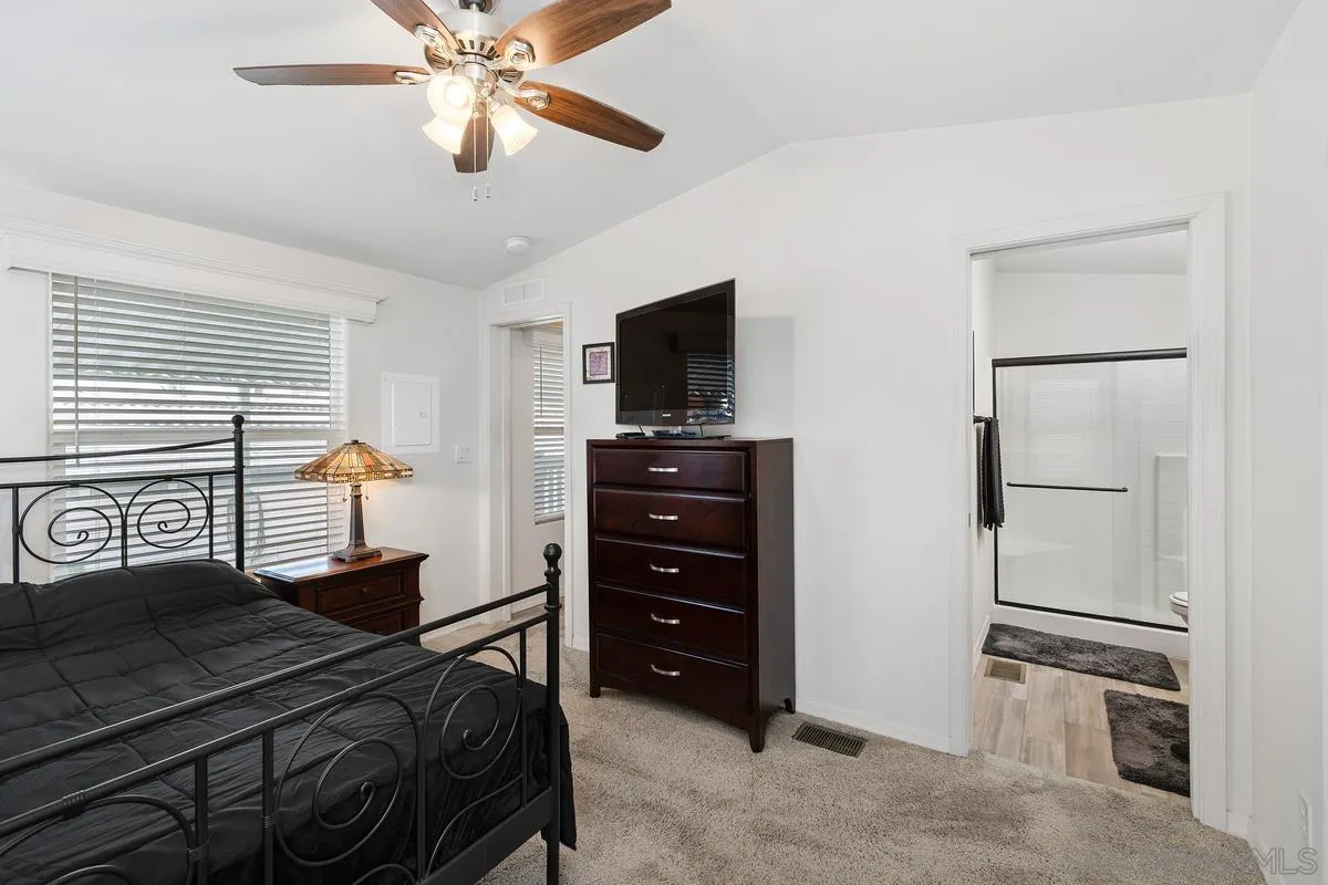 8545 Mission Gorge Road, Unit SPC 336A Santee, CA 92071 - Photo 16 of 28 a bedroom with a bed and a television