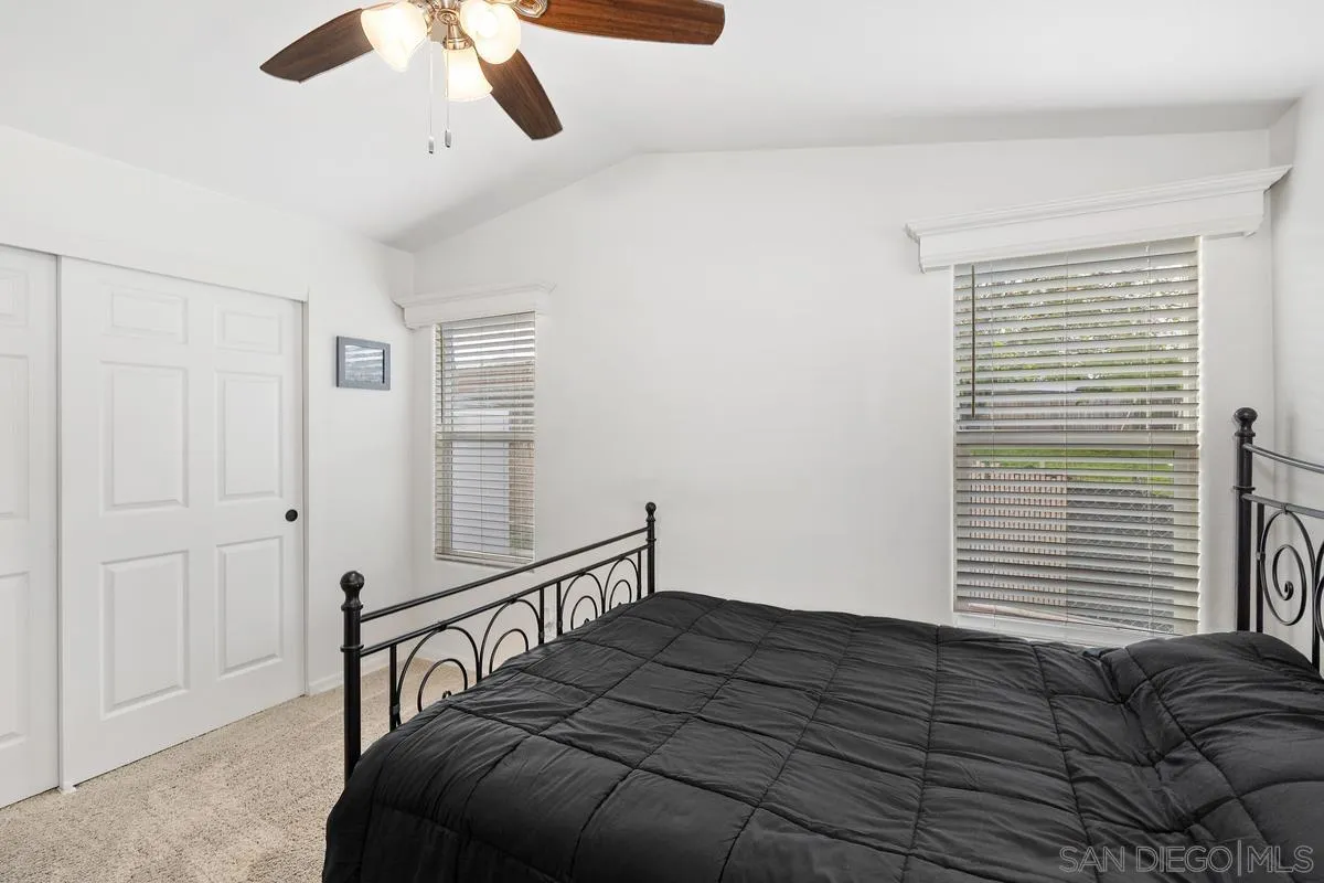 8545 Mission Gorge Road, Unit SPC 336A Santee, CA 92071 - Photo 18 of 28 a bedroom with a bed lamp and a large window