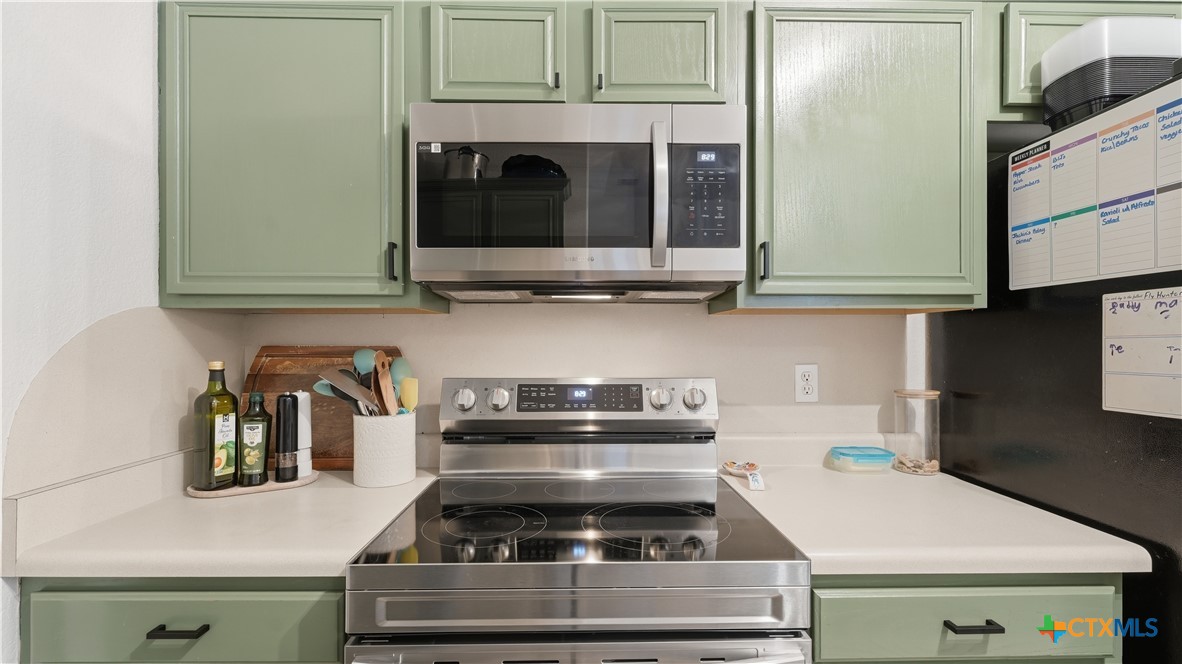 2216 Hornsby Spring Branch, TX 78070 - Photo 12 of 33 a kitchen with a stove and a microwave