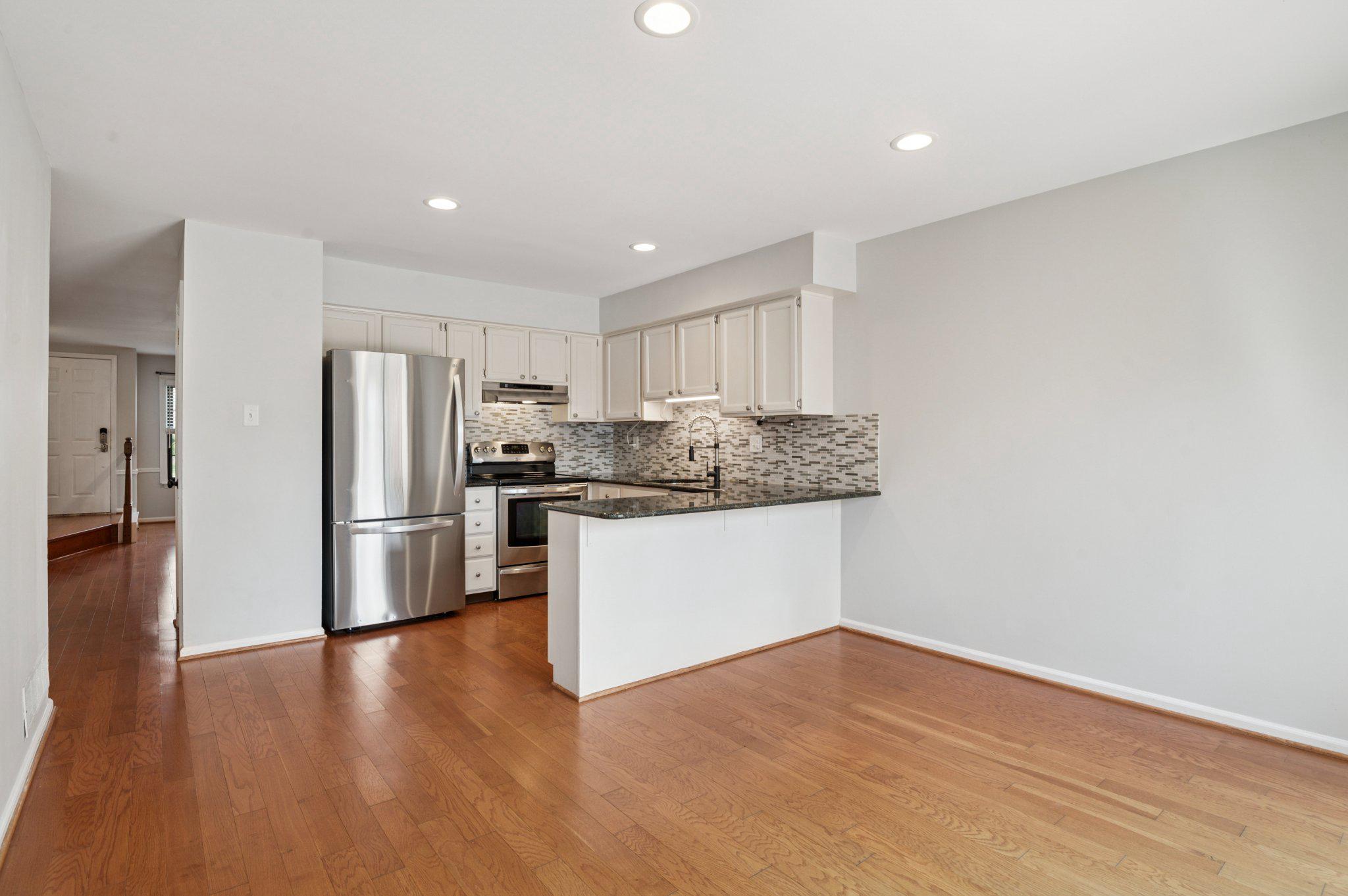 237 McIntosh Road, Unit 82 West Chester, PA 19382 - Photo 5 of 18 a kitchen with stainless steel appliances granite countertop a refrigerator sink and white cabinets
