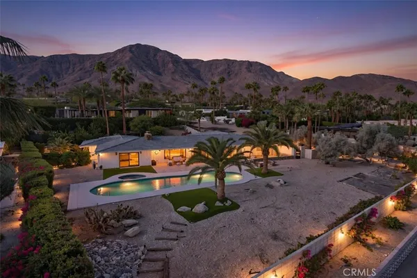 a view of swimming pool with a yard and mountain view