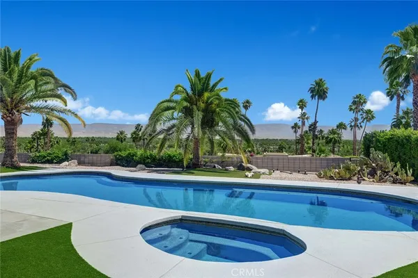 a view of a swimming pool with a sink and a yard