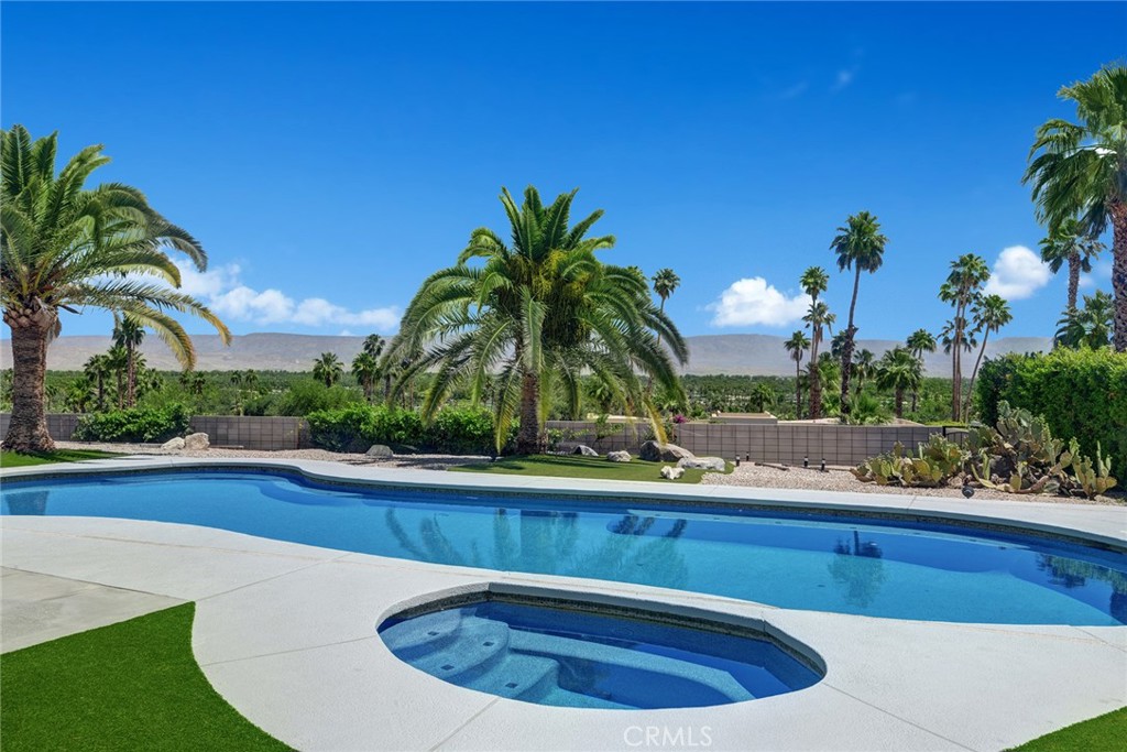 40600 Tonopah Road Rancho Mirage, CA 92270 - Photo 13 of 28 a view of a swimming pool with a sink and a yard