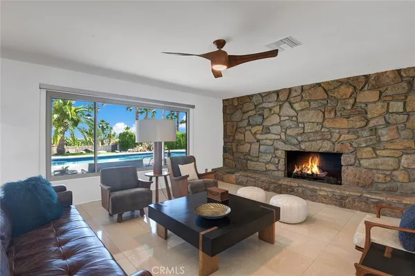 a living room with furniture and a fireplace