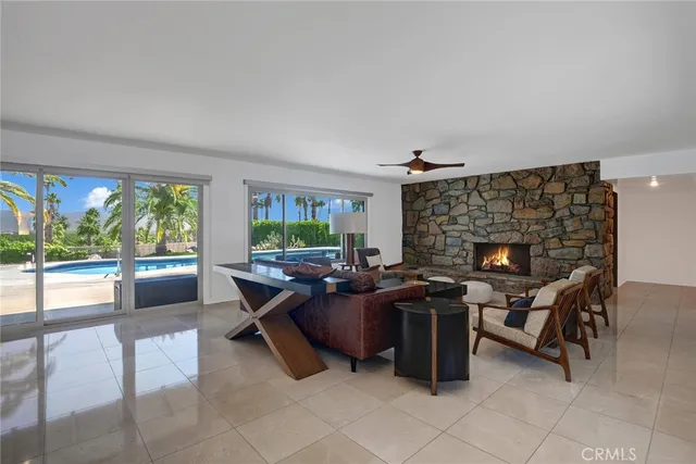 a living room with furniture a fireplace and a table