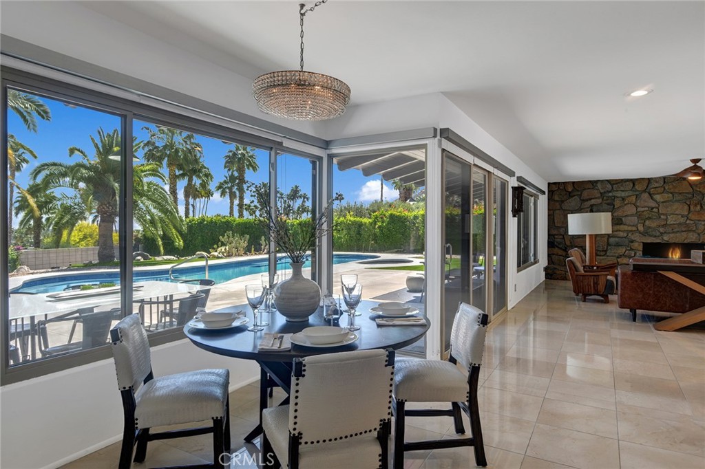 40600 Tonopah Road Rancho Mirage, CA 92270 - Photo 20 of 27 a view of a dining room with furniture large windows and wooden floor