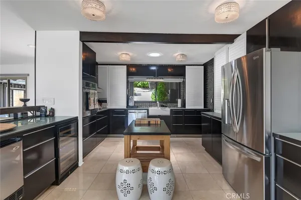 a kitchen with stainless steel appliances granite countertop a refrigerator and a stove