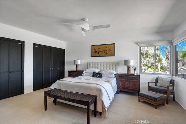 a bedroom with a bed and a couch