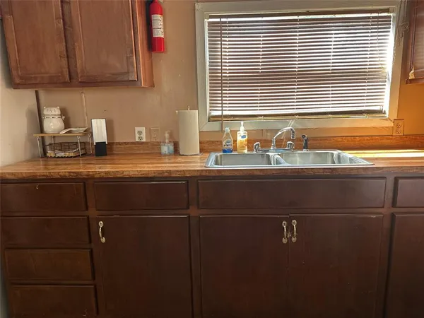 a kitchen with a sink cabinets and window