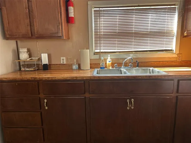 a kitchen with a sink cabinets and window