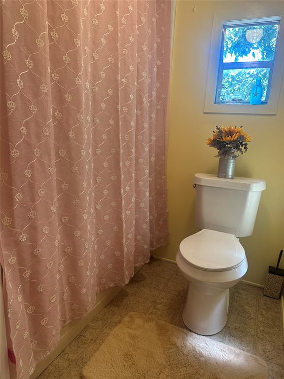 142 Lonely Pine Road Waco, TX 76708 - Photo 17 of 31 a white toilet sitting next to a small bathroom