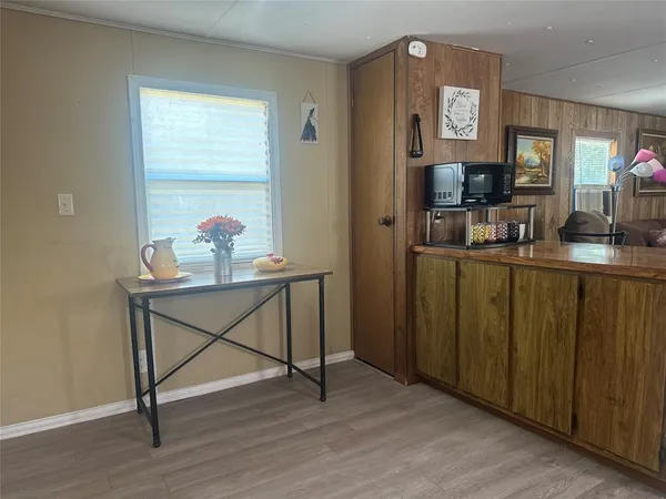 a view of room with window and wooden floor