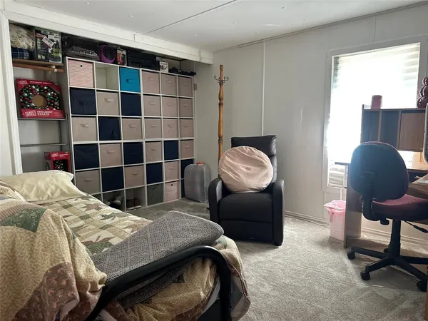 a bedroom with a bed and a mirror