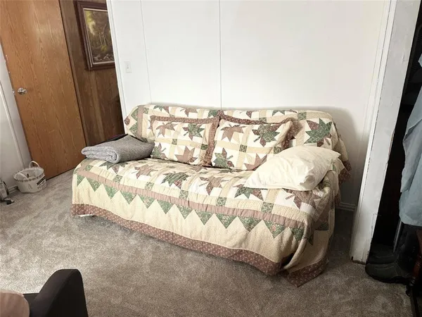 a view of a livingroom with furniture and a window