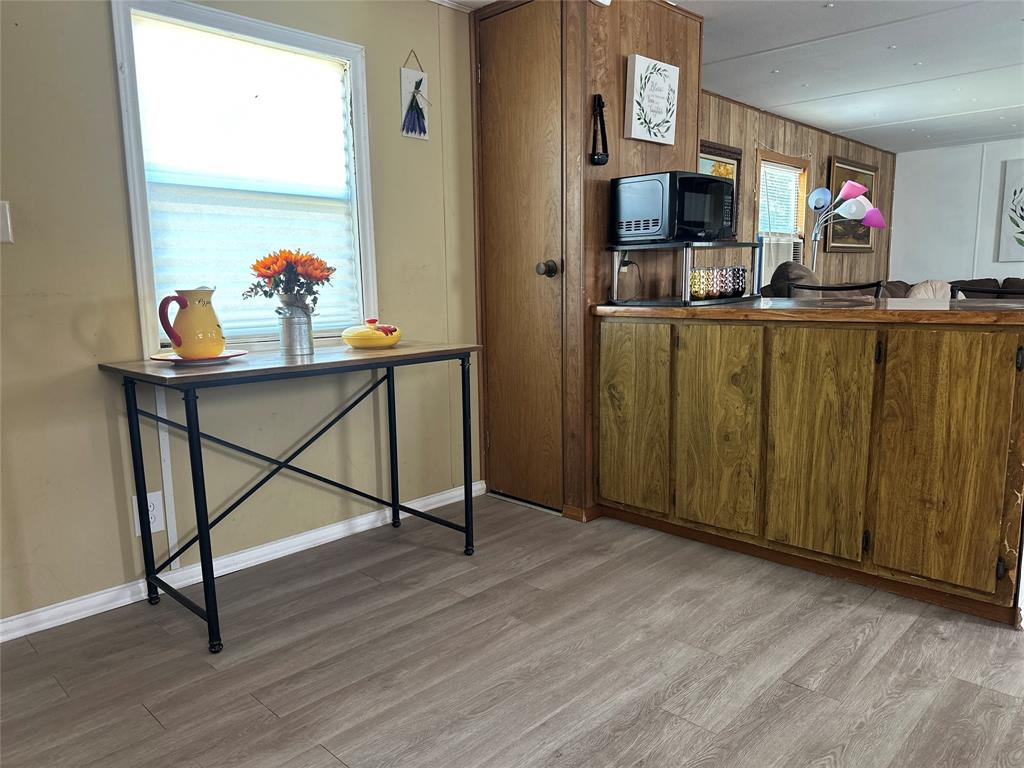 142 Lonely Pine Road Waco, TX 76708 - Photo 25 of 31 a view of kitchen dining room with wooden floor and window