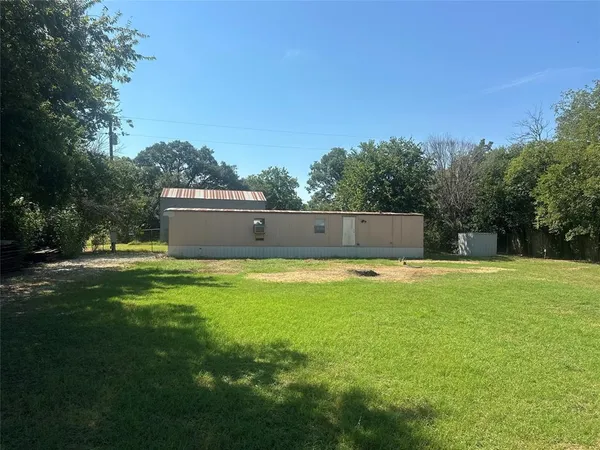 a view of a swimming pool with a big yard and large trees