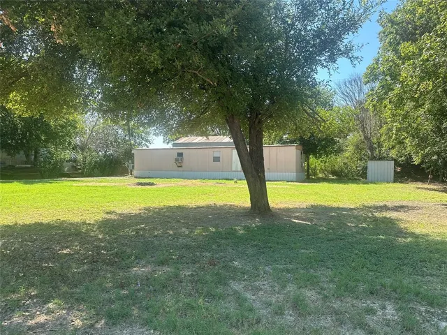a view of a backyard with a small cabin