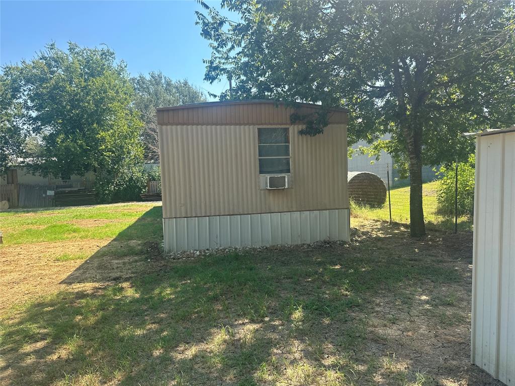 142 Lonely Pine Road Waco, TX 76708 - Photo 28 of 31 a view of a backyard with a small cabin