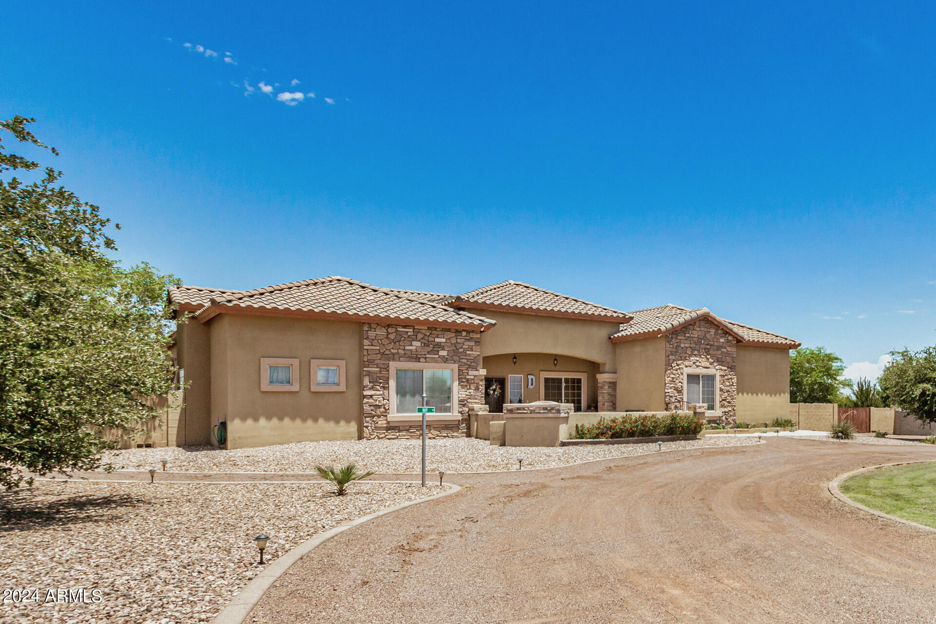 20716 West Telegram Path Road Buckeye, AZ 85326 - Photo 11 of 65 a front view of a house with a yard and garage