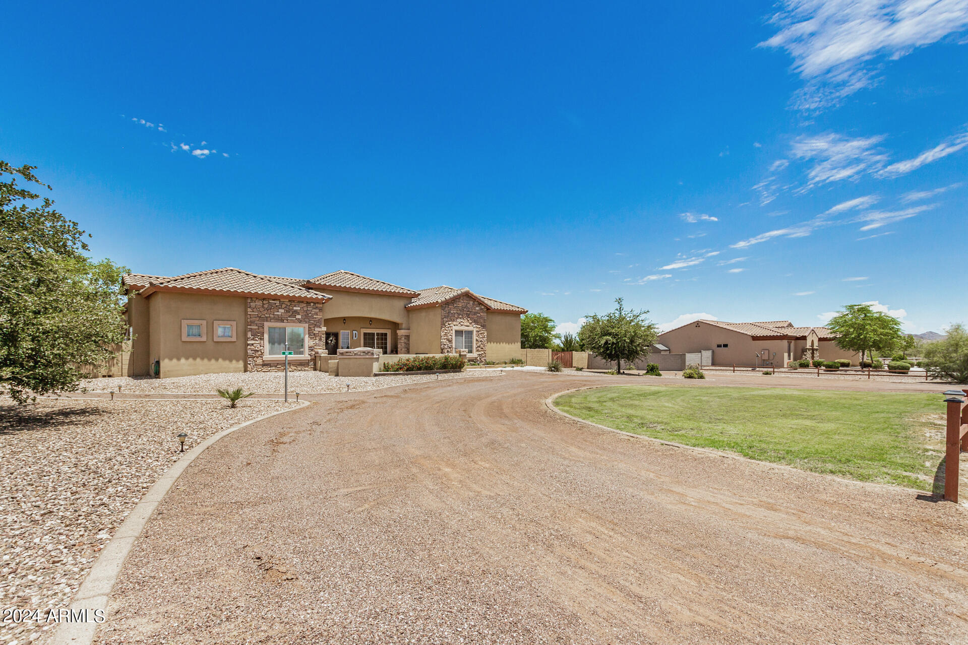 20716 West Telegram Path Road Buckeye, AZ 85326 - Photo 12 of 65 a front view of a house with a yard and garage
