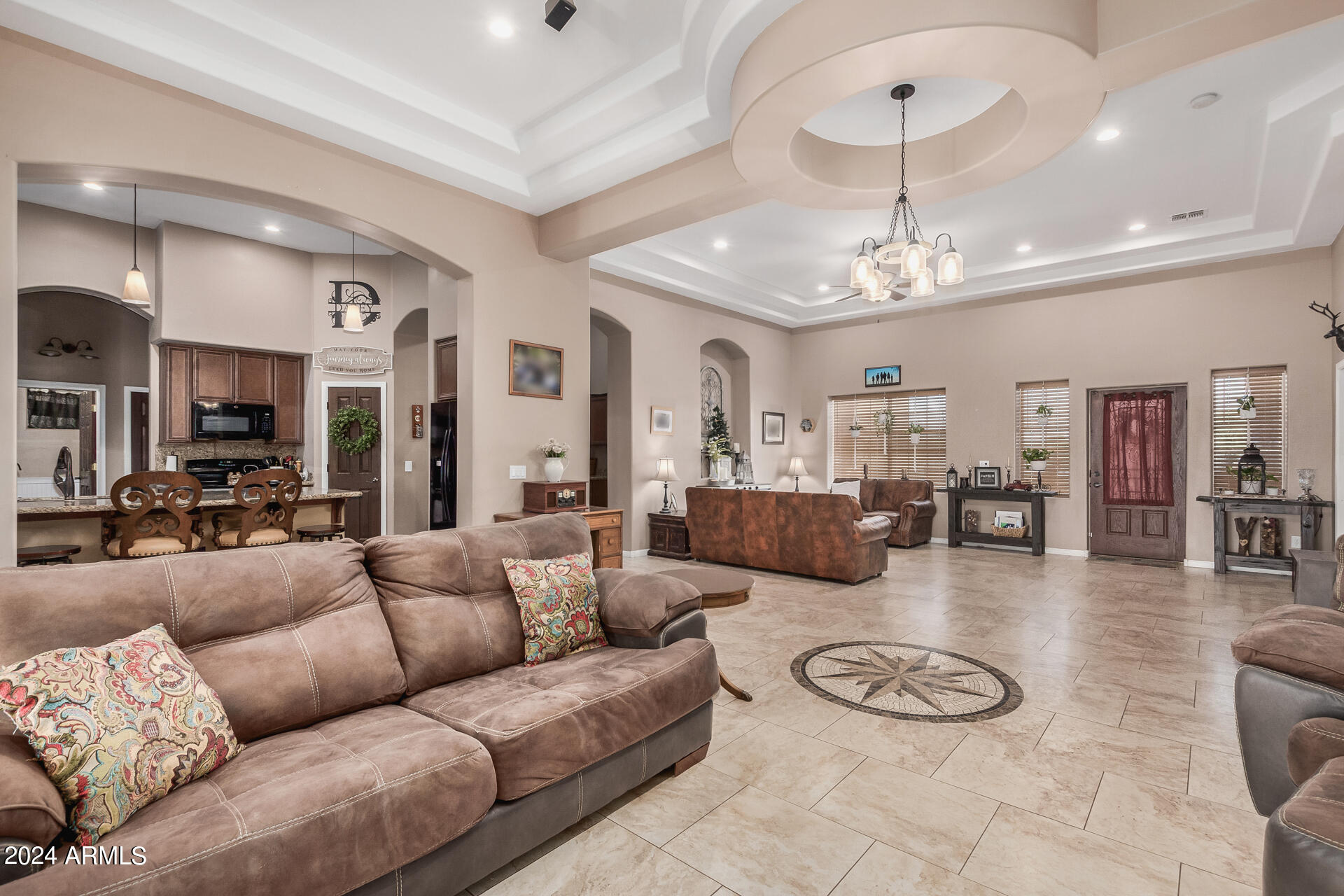 20716 West Telegram Path Road Buckeye, AZ 85326 - Photo 22 of 65 a living room with furniture kitchen and a chandelier