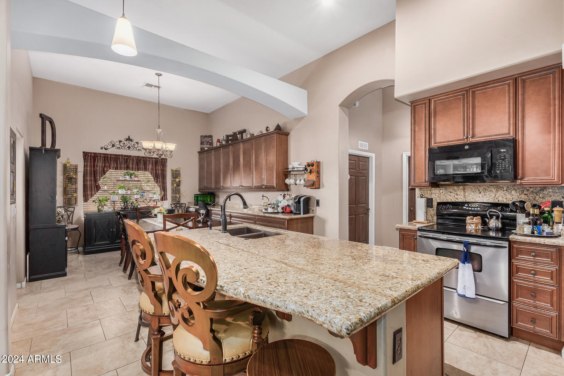 20716 West Telegram Path Road Buckeye, AZ 85326 - Photo 31 of 65 a kitchen with stainless steel appliances granite countertop a stove refrigerator and cabinets