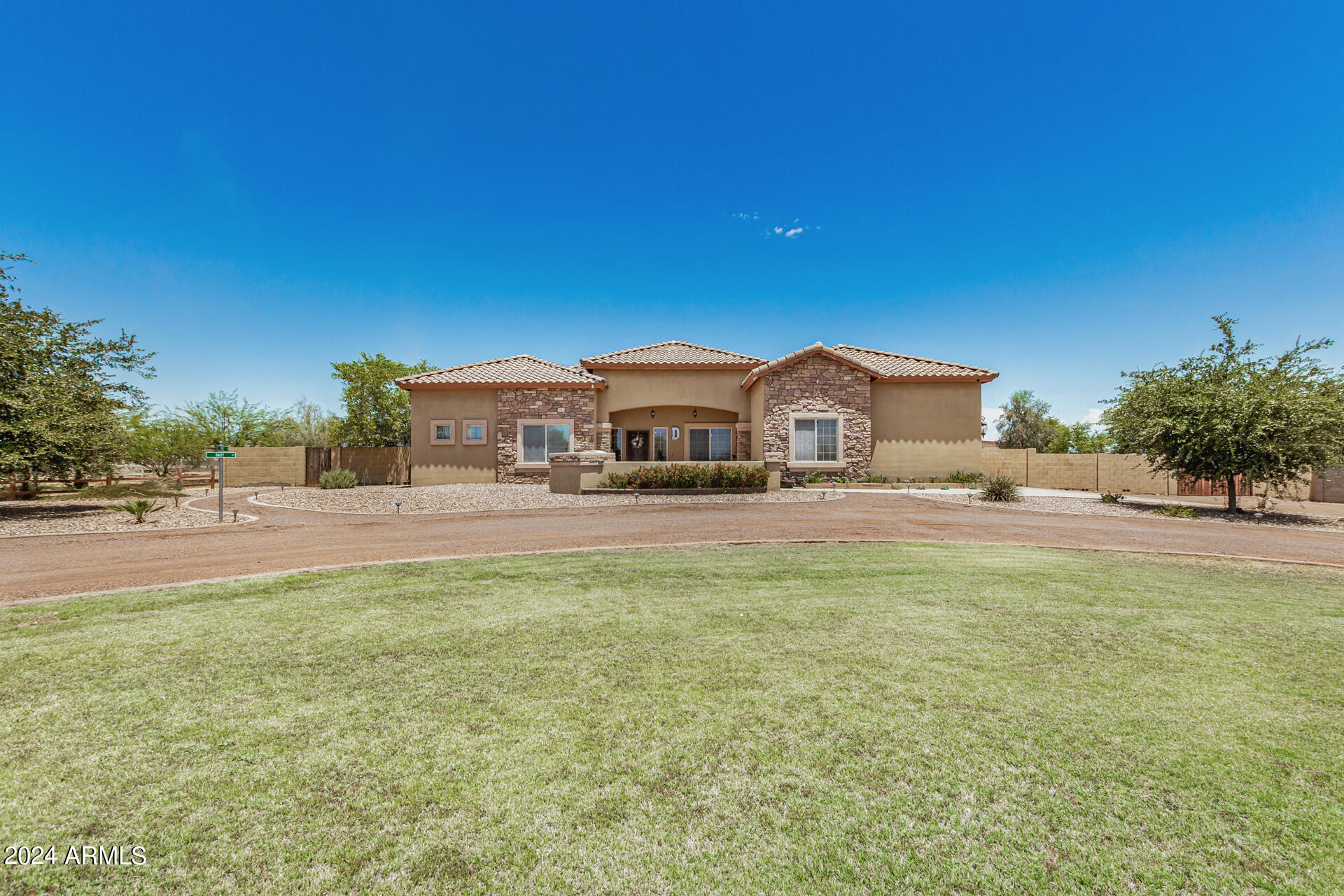 20716 West Telegram Path Road Buckeye, AZ 85326 - Photo 4 of 65 a front view of a house with a garden and yard