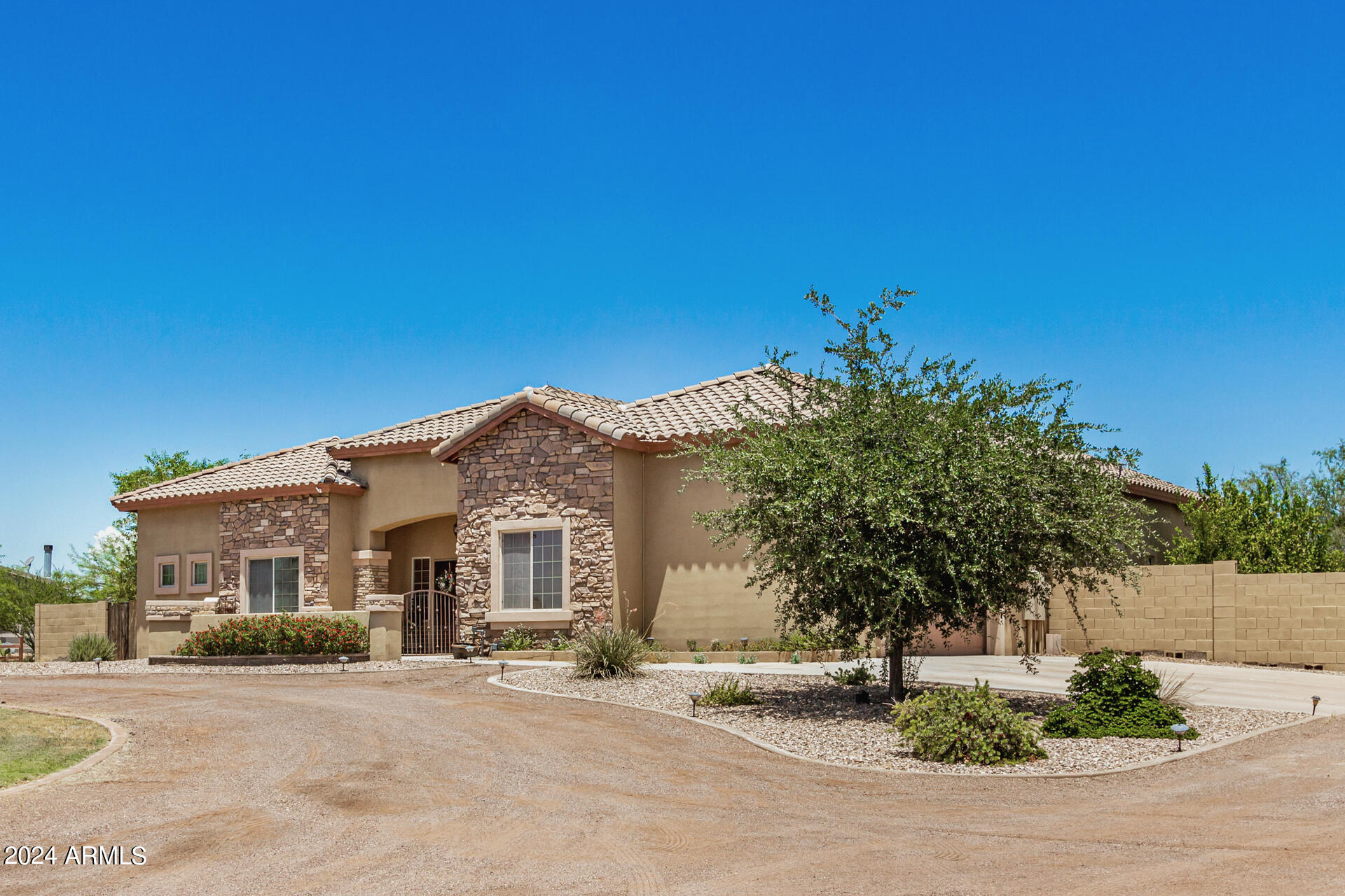 20716 West Telegram Path Road Buckeye, AZ 85326 - Photo 6 of 65 a front view of a house with a yard and garage
