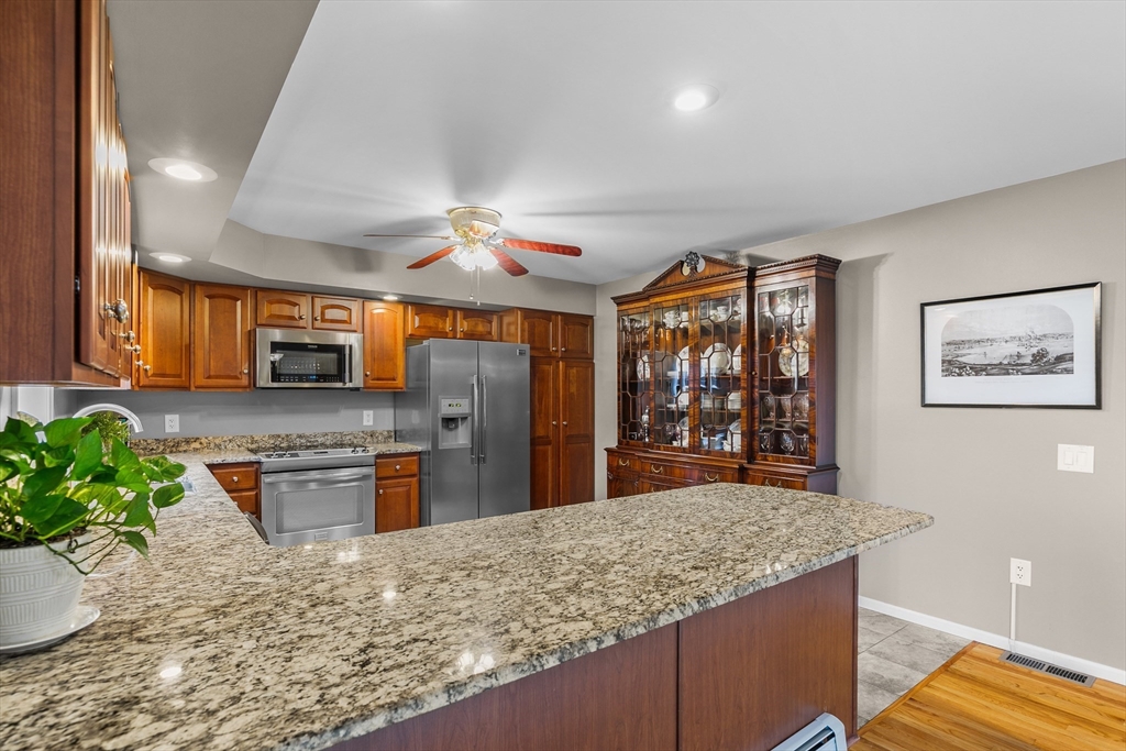 780 Dickinson Street Fall River, MA 02721 - Photo 15 of 42 a kitchen with stainless steel appliances granite countertop sink stove and refrigerator