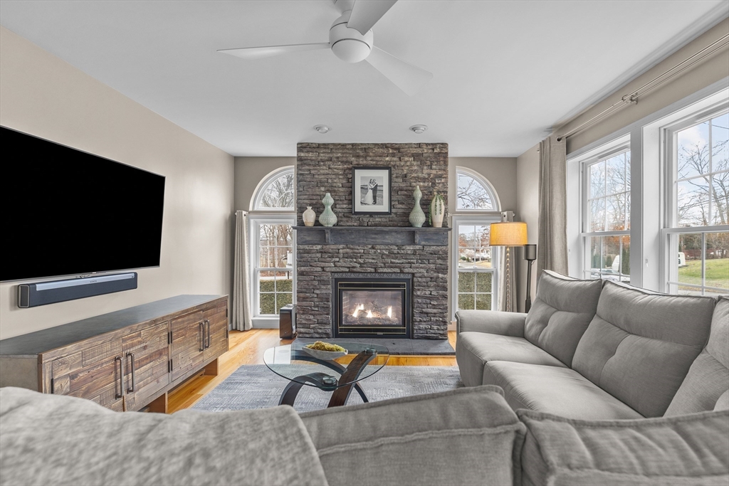 780 Dickinson Street Fall River, MA 02721 - Photo 6 of 42 a living room with furniture a flat screen tv and a fireplace