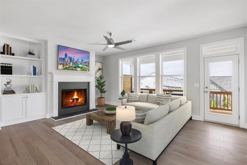 a living room with fireplace furniture and a wooden floor