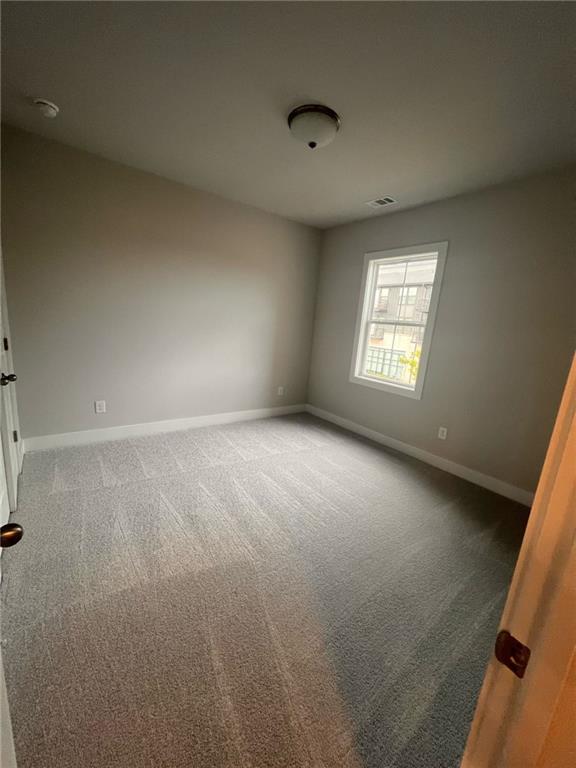 1220 Waterfall Court Cumming, GA 30041 - Photo 20 of 29 an empty room with a windows and closet