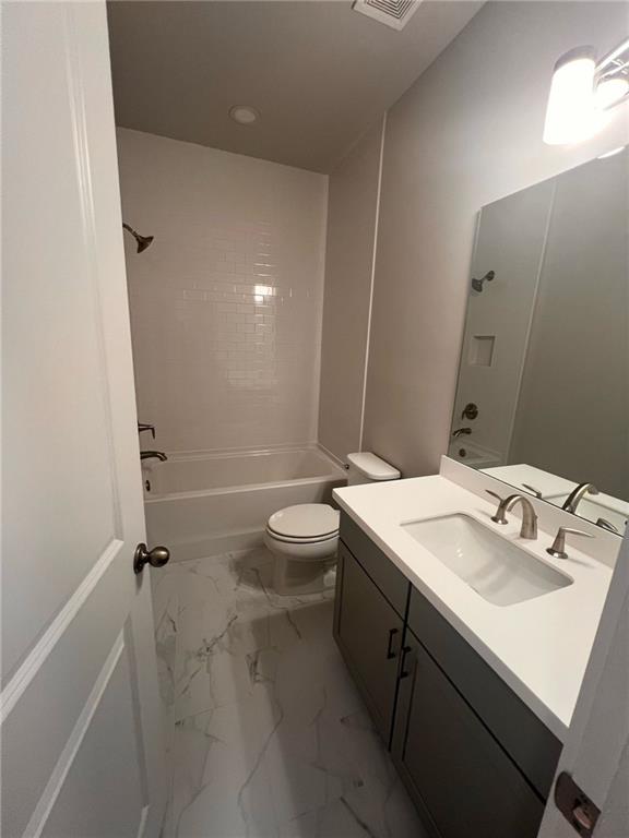 1220 Waterfall Court Cumming, GA 30041 - Photo 21 of 29 a bathroom with a sink a toilet and shower