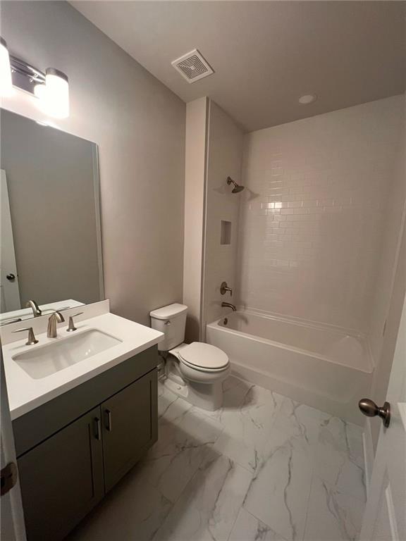 1220 Waterfall Court Cumming, GA 30041 - Photo 26 of 29 a bathroom with a sink a toilet and shower